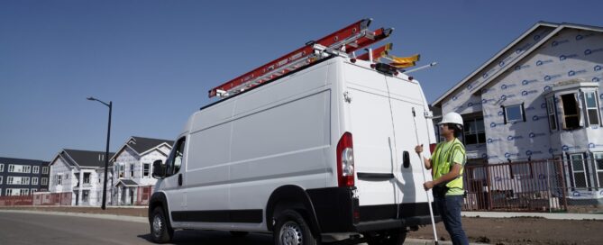 Worker using the ErgoRack ladder rack on a high-roof Ford Transit